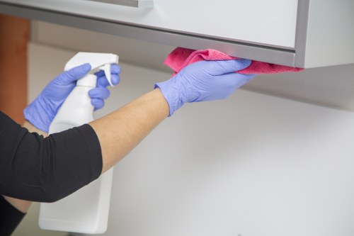 Cleaners managing hoses and wet floors safely during service